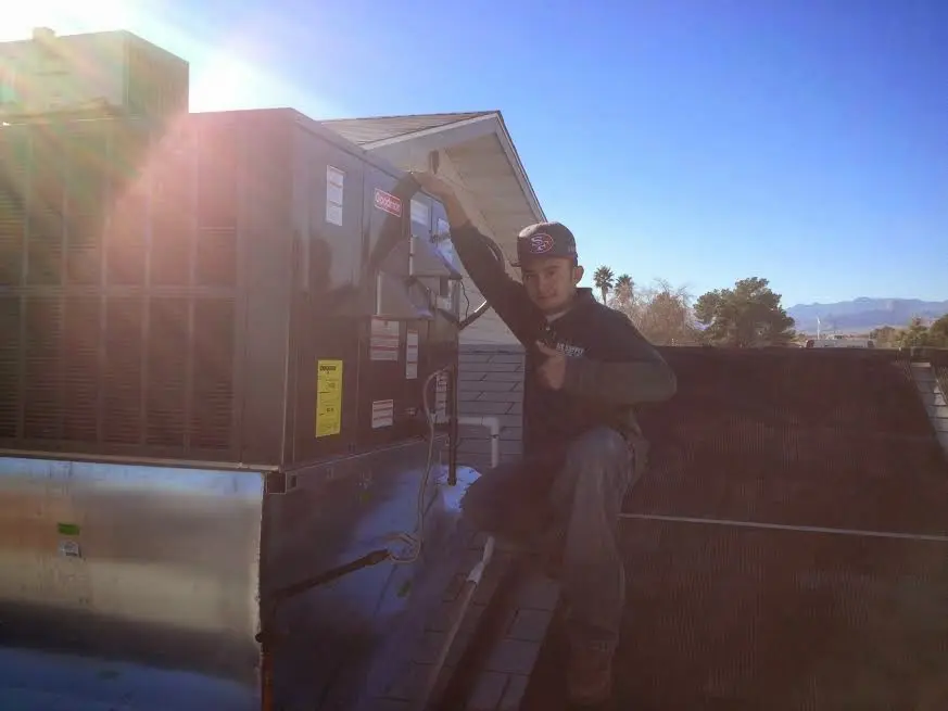 HVAC technician performing HVAC Inspection on a rooftop unit in Maxatawny